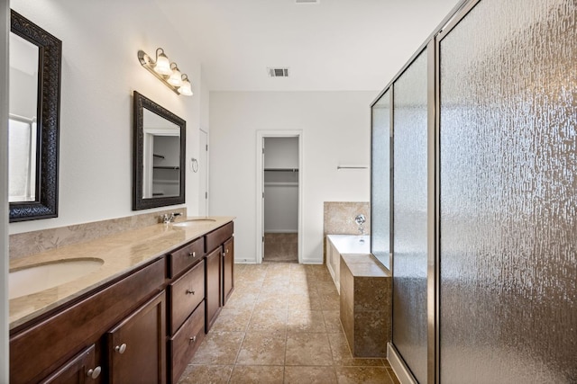 full bath with visible vents, a shower stall, a sink, and a bath