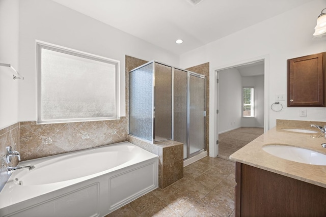 full bathroom featuring a sink, a shower stall, a garden tub, and double vanity
