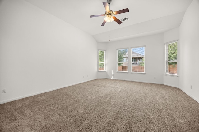 empty room featuring carpet flooring, a ceiling fan, baseboards, lofted ceiling, and visible vents