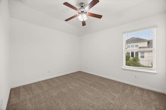 unfurnished room with baseboards, a ceiling fan, and carpet