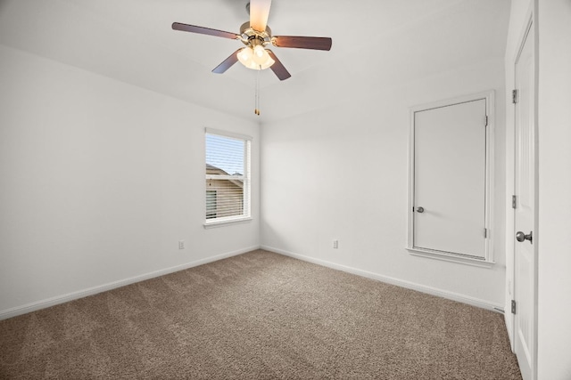 empty room with baseboards, a ceiling fan, and carpet flooring