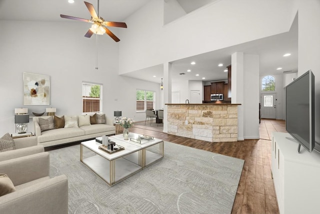 5929 Gunnison Turn Rd, Austin, TX 78738 - living area featuring hardwood / wood-style flooring, ceiling fan, recessed lighting, and a towering ceiling
