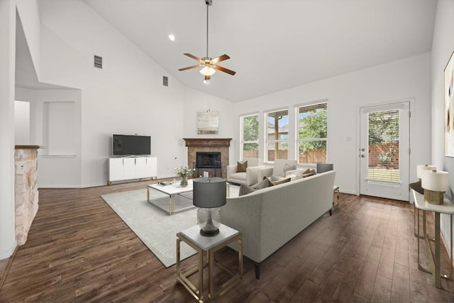 5929 Gunnison Turn Rd, Austin, TX 78738 - living room featuring a tiled fireplace, dark wood finished floors, ceiling fan, and high vaulted ceiling