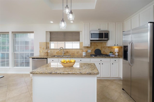 kitchen with a sink, white cabinetry, light tile patterned floors, and stainless steel appliances