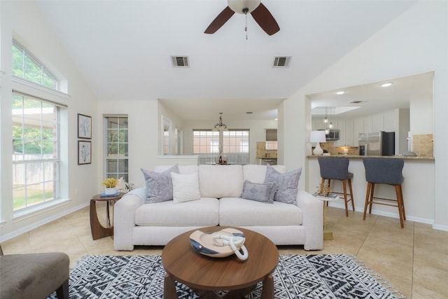 living room featuring light tile patterned floors, visible vents, and a healthy amount of sunlight