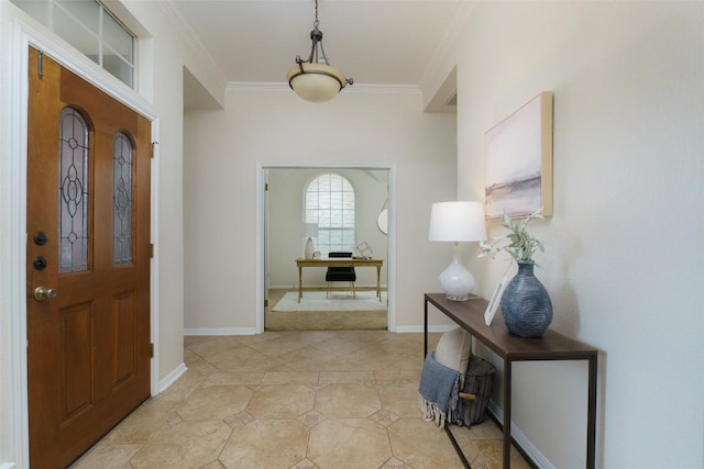foyer entrance with light tile patterned flooring, baseboards, and ornamental molding