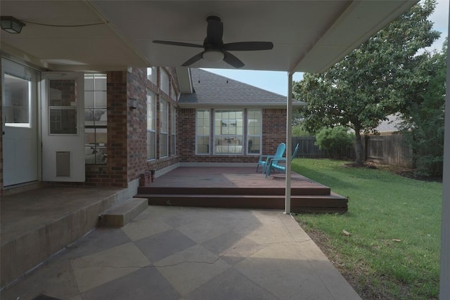view of patio featuring ceiling fan, a wooden deck, and a fenced backyard