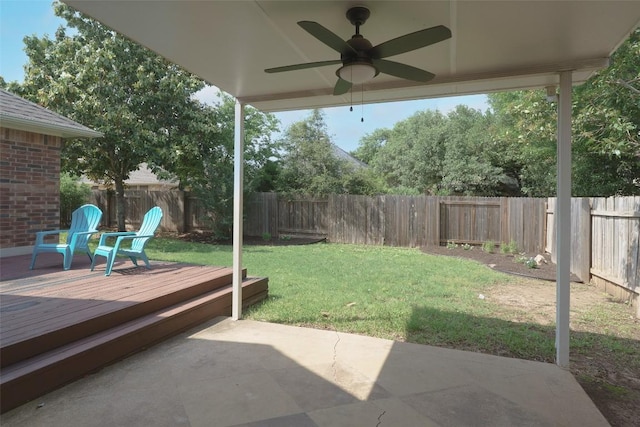 view of yard featuring a ceiling fan, a fenced backyard, a patio area, and a wooden deck