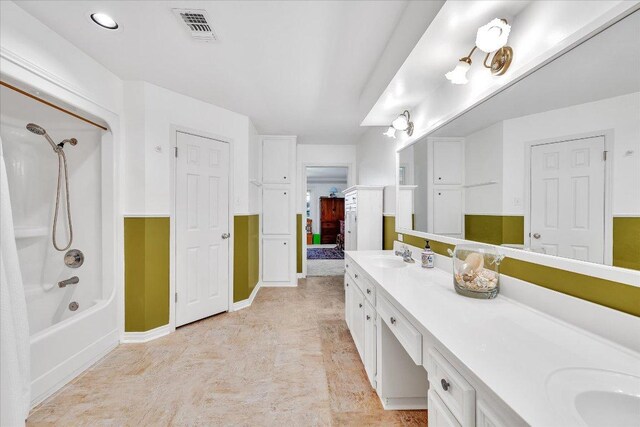 full bathroom featuring double vanity, visible vents, a sink, baseboards, and bathing tub / shower combination