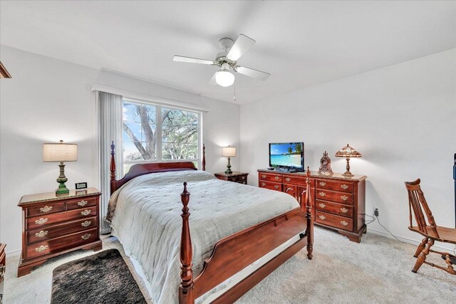 bedroom featuring baseboards, ceiling fan, and light colored carpet