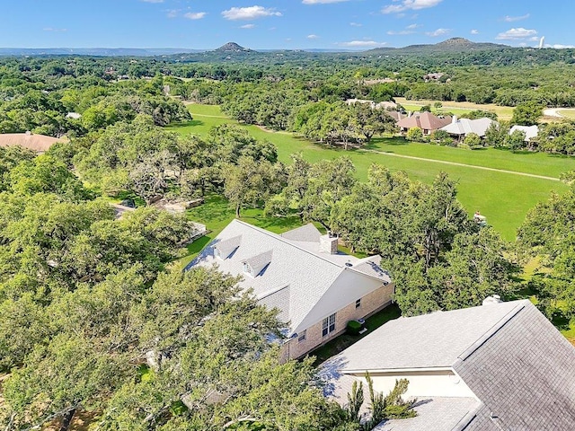 bird's eye view with a wooded view