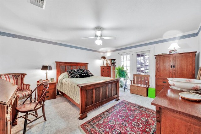 bedroom featuring visible vents, ornamental molding, access to exterior, ceiling fan, and light colored carpet