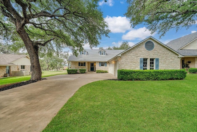 view of front of home with a garage, driveway, stone siding, and a front lawn