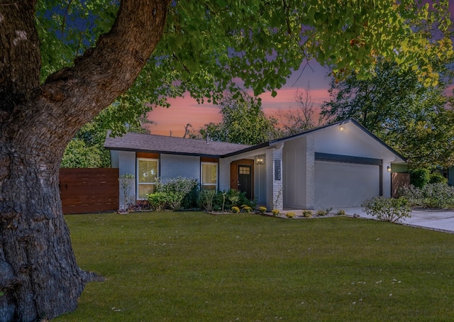 10429 Firethorn Ln, Austin, TX 78750 - ranch-style home with fence, a front lawn, brick siding, a garage, and driveway