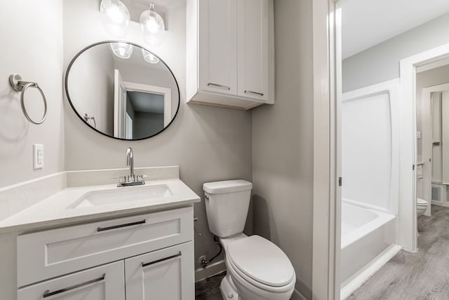 10429 Firethorn Ln, Austin, TX 78750 - full bath with vanity, baseboards, wood finished floors, and toilet