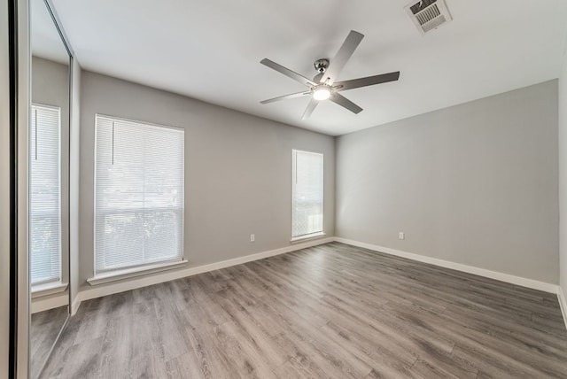 10429 Firethorn Ln, Austin, TX 78750 - unfurnished room with a ceiling fan, baseboards, visible vents, and wood finished floors