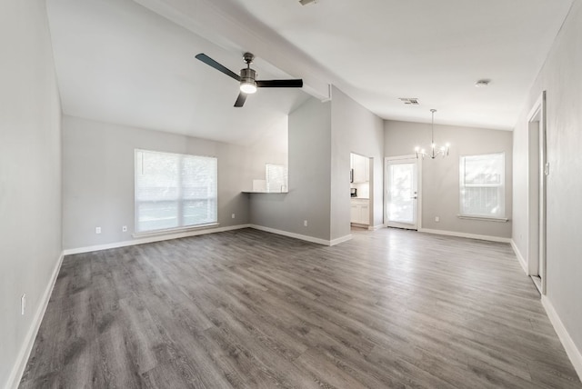 10429 Firethorn Ln, Austin, TX 78750 - unfurnished living room with lofted ceiling with beams, wood finished floors, and a wealth of natural light