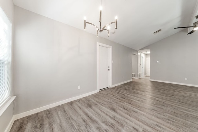 10429 Firethorn Ln, Austin, TX 78750 - interior space with visible vents, wood finished floors, baseboards, ceiling fan with notable chandelier, and vaulted ceiling
