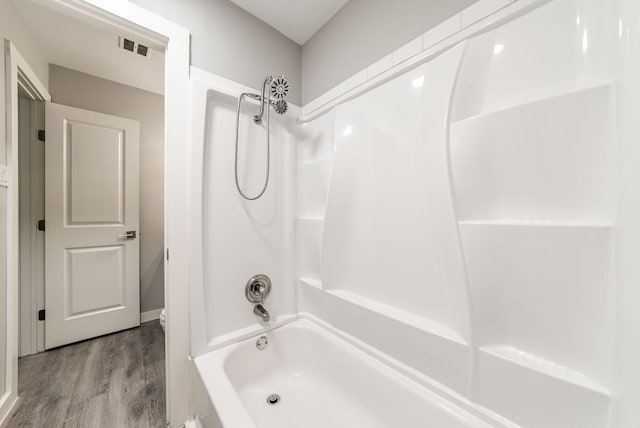 10429 Firethorn Ln, Austin, TX 78750 - bathroom featuring visible vents, wood finished floors, and bathtub / shower combination