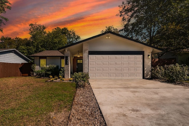 10429 Firethorn Ln, Austin, TX 78750 - view of front of property with a lawn, an attached garage, brick siding, and concrete driveway