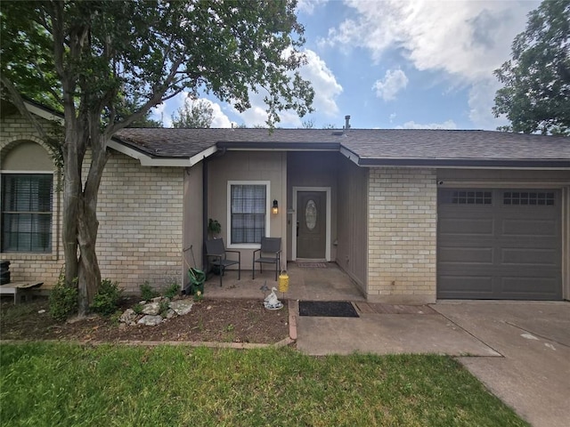 ranch-style house with brick siding, a shingled roof, an attached garage, and driveway