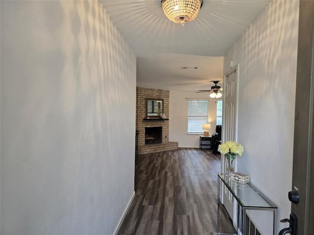 hallway with baseboards and wood finished floors