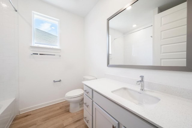 full bathroom with shower / tub combination, vanity, toilet, baseboards, and wood finished floors