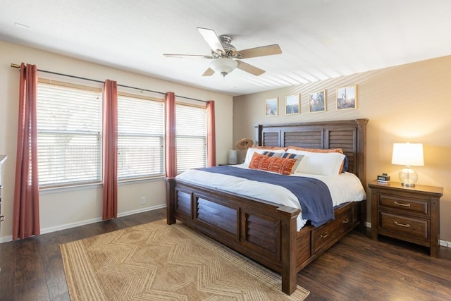 bedroom featuring a ceiling fan, baseboards, and dark wood-type flooring