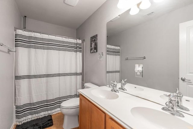 full bathroom featuring a sink, toilet, and visible vents