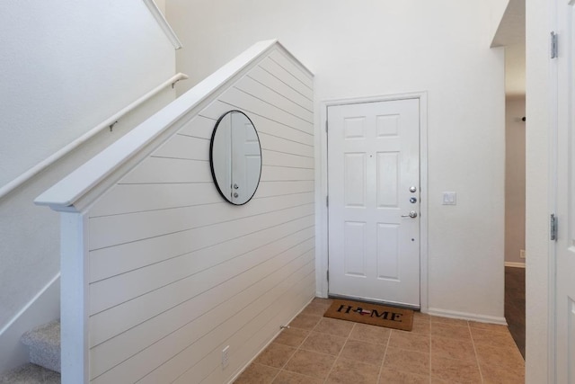 doorway featuring stairway and tile patterned floors