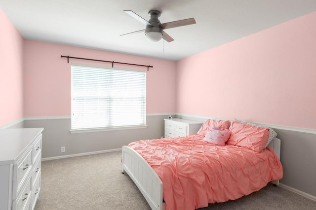 bedroom featuring baseboards, ceiling fan, and light carpet