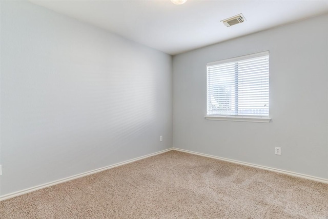 unfurnished room featuring carpet floors, baseboards, and visible vents