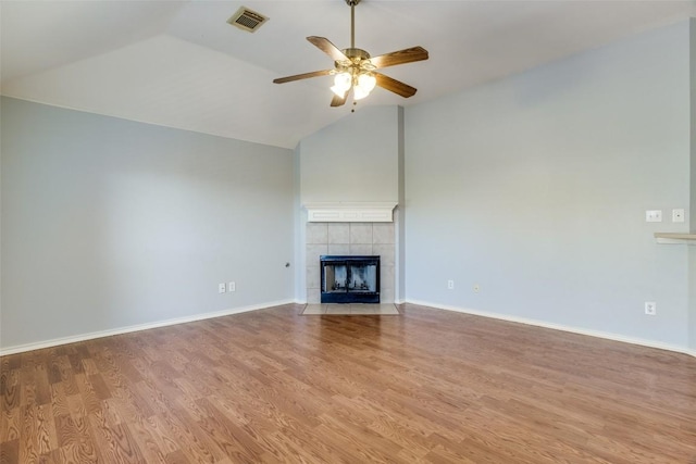 unfurnished living room featuring visible vents, a ceiling fan, light wood-style flooring, and a tiled fireplace