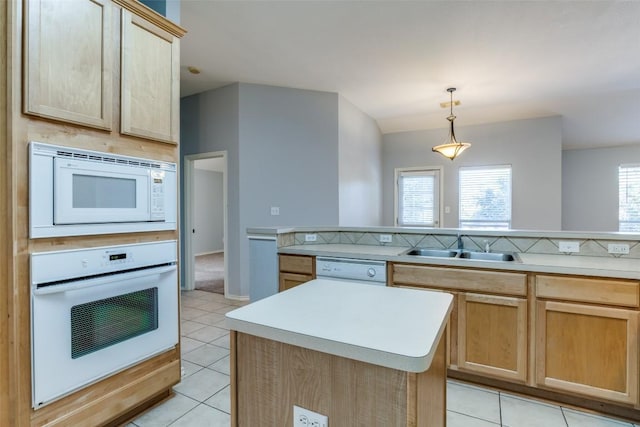 kitchen with light brown cabinetry, white appliances, light countertops, a sink, and light tile patterned floors