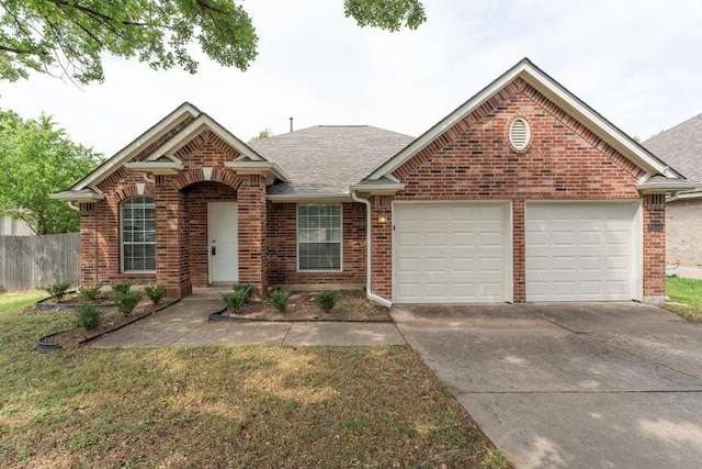 7418 W Magic Mountain Ln, Round Rock, TX 78681 - ranch-style house featuring an attached garage, fence, concrete driveway, brick siding, and roof with shingles