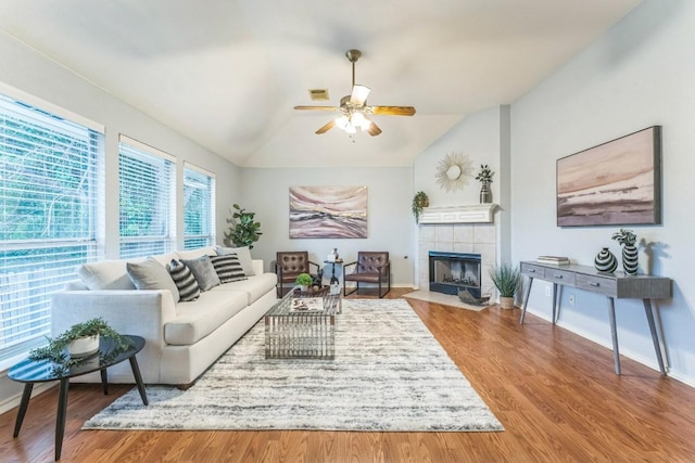 7418 W Magic Mountain Ln, Round Rock, TX 78681 - living area featuring a ceiling fan, lofted ceiling, a tiled fireplace, and baseboards