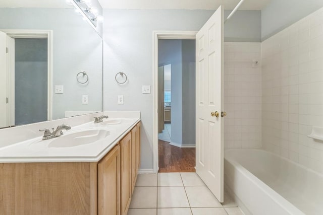 7418 W Magic Mountain Ln, Round Rock, TX 78681 - bathroom with a sink, double vanity, shower / bath combination, and tile patterned floors