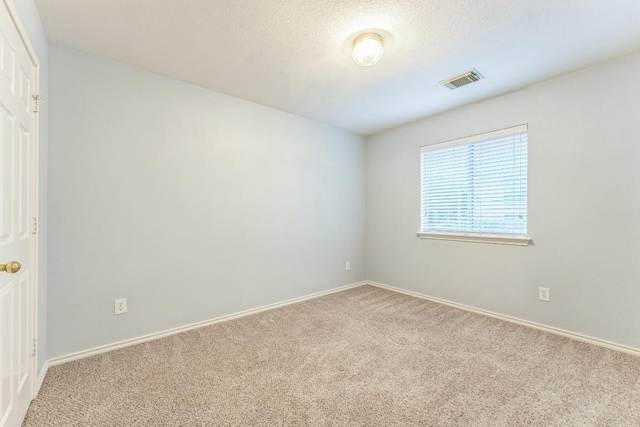 7418 W Magic Mountain Ln, Round Rock, TX 78681 - unfurnished room with a textured ceiling, carpet flooring, baseboards, and visible vents