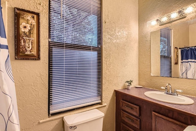200 Woodlands Dr, Bastrop, TX 78602 - full bathroom with a textured wall, vanity, and a shower with shower curtain