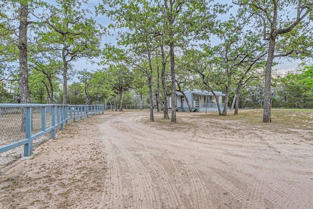 view of street featuring dirt driveway