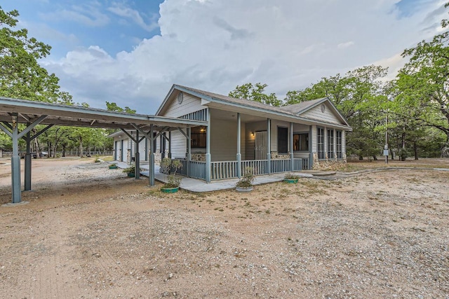 view of front of home featuring a sunroom and a carport