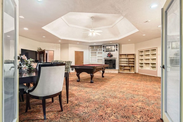 game room featuring built in shelves, a raised ceiling, carpet floors, and pool table