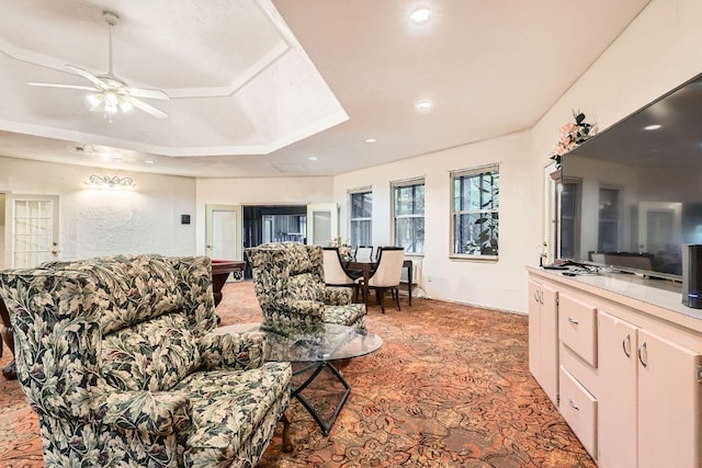 living room with light colored carpet, a ceiling fan, and recessed lighting