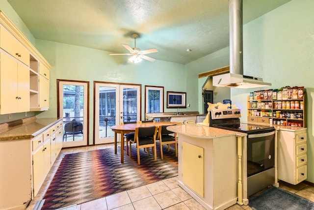 200 Woodlands Dr, Bastrop, TX 78602 - kitchen with electric range, open shelves, ceiling fan, and light tile patterned floors
