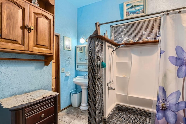 bathroom featuring tile patterned flooring and a textured wall