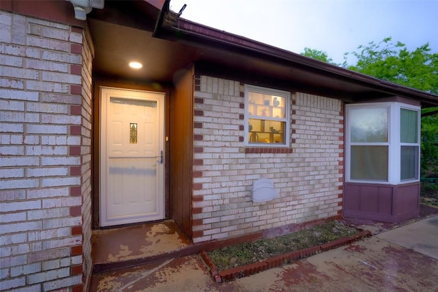 entrance to property with brick siding