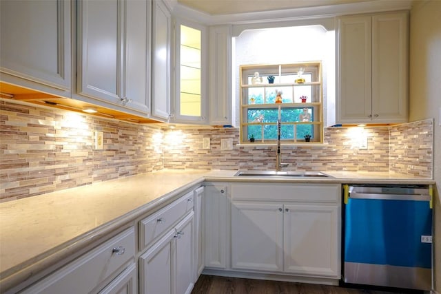 kitchen featuring light countertops, white cabinetry, tasteful backsplash, a sink, and dishwasher