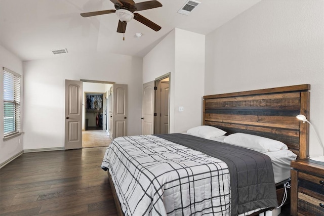 bedroom featuring visible vents, lofted ceiling, wood finished floors, baseboards, and a ceiling fan