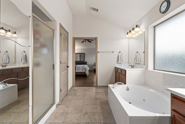ensuite bathroom with visible vents, a sink, a stall shower, and vaulted ceiling