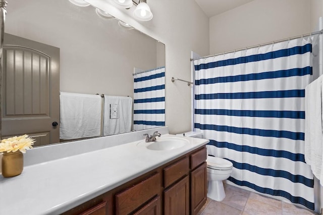 bathroom featuring vanity, a shower with shower curtain, tile patterned floors, and toilet